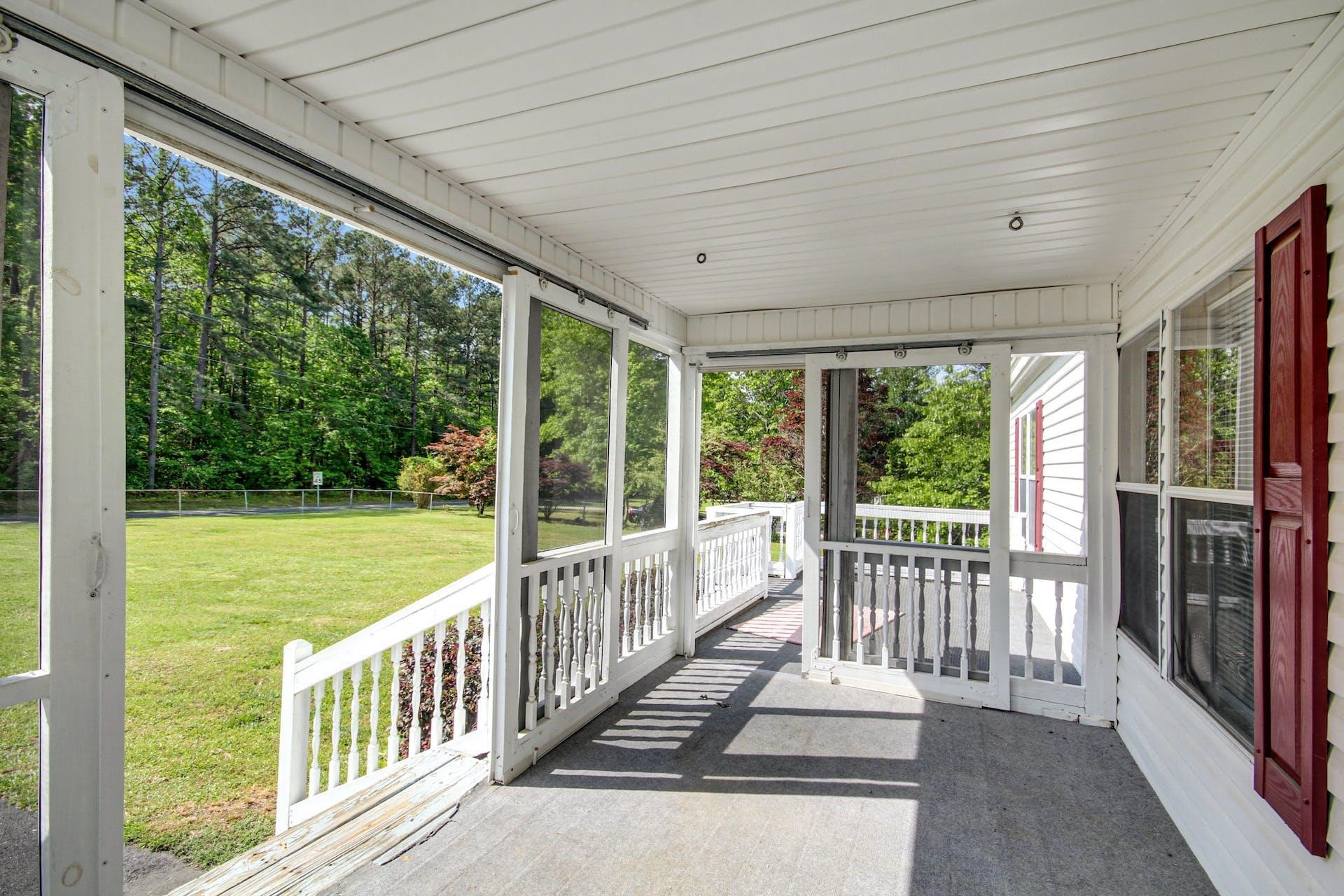 8144 Mt Pleasant Church Road Willow Spring, NC 27592 - Photo 5 of 25 a view of a porch with wooden floor and outdoor space