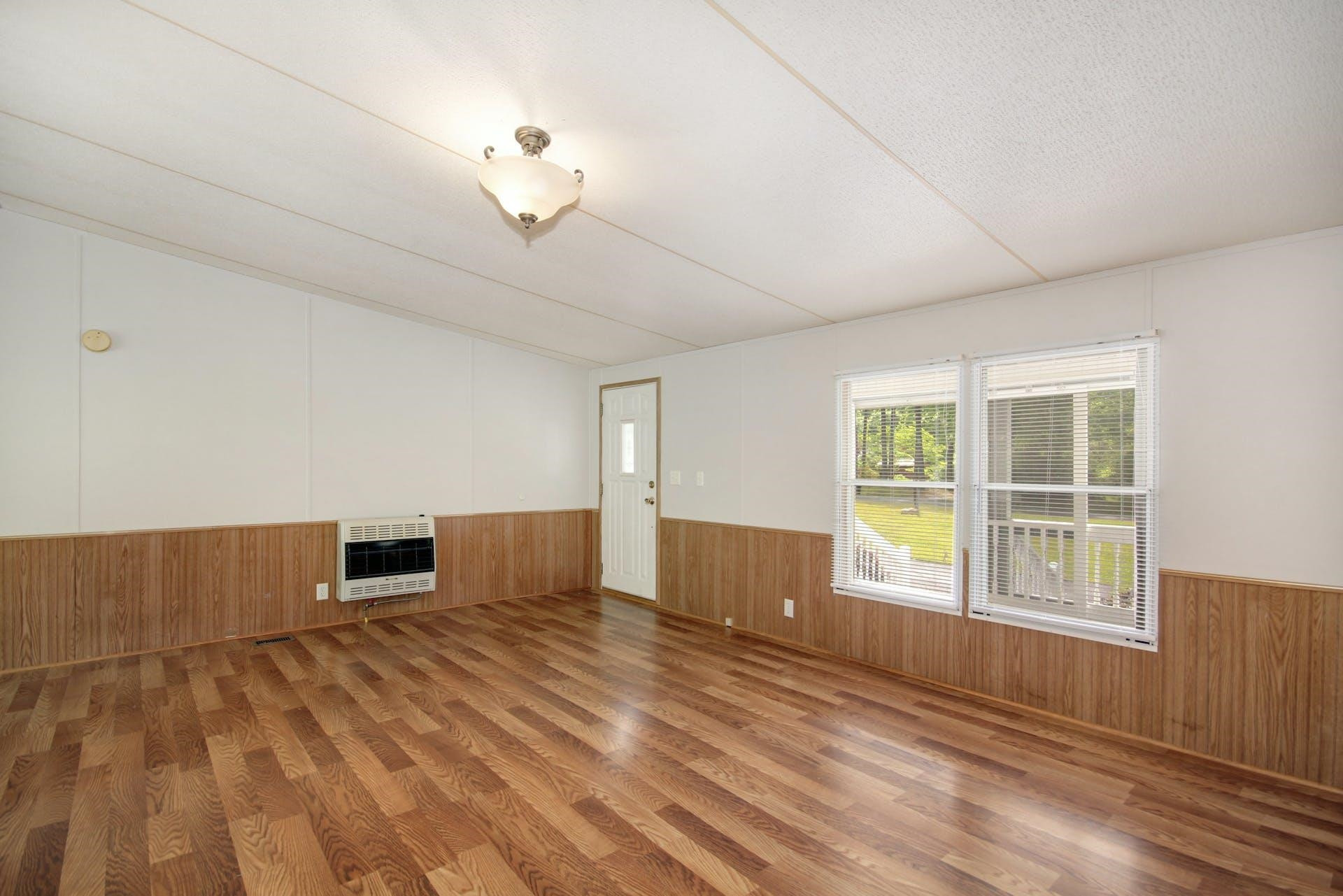 8144 Mt Pleasant Church Road Willow Spring, NC 27592 - Photo 7 of 25 a view of empty room with wooden floor and fan