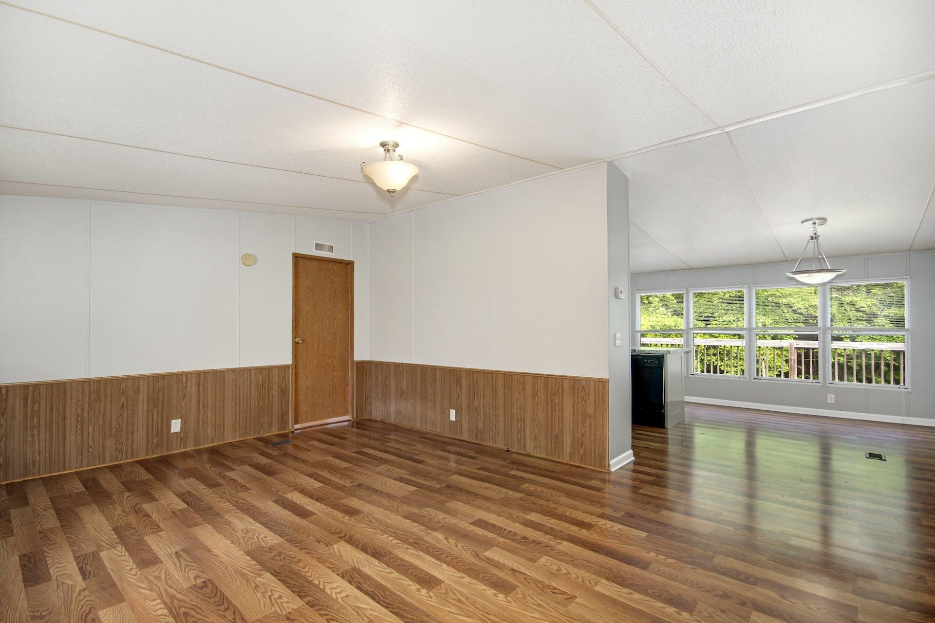 8144 Mt Pleasant Church Road Willow Spring, NC 27592 - Photo 8 of 25 an empty room with wooden floor and windows