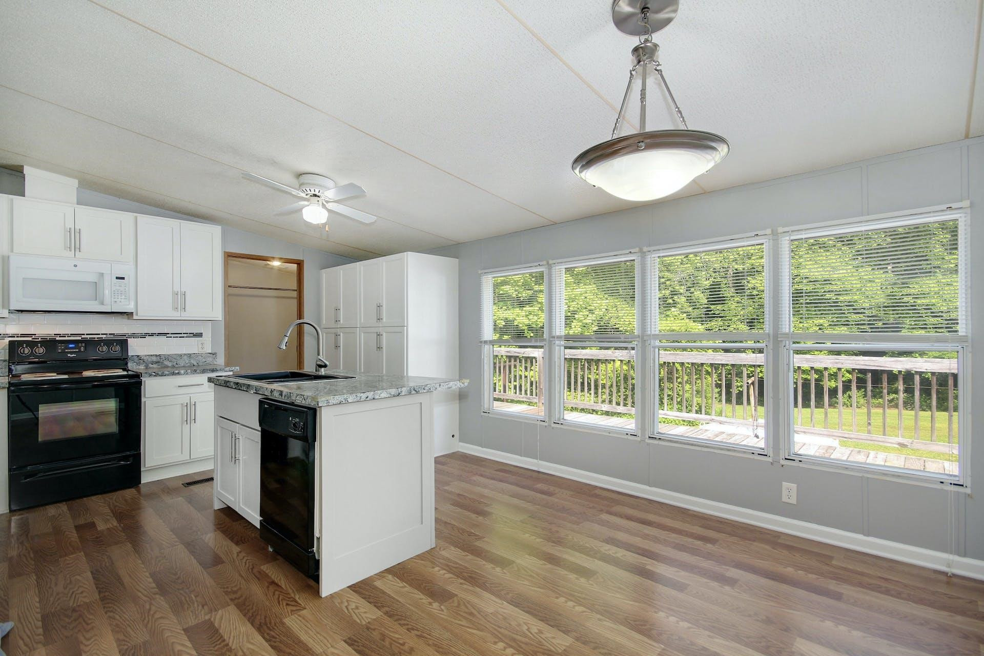 8144 Mt Pleasant Church Road Willow Spring, NC 27592 - Photo 9 of 25 a kitchen with stainless steel appliances granite countertop a stove a sink and a refrigerator