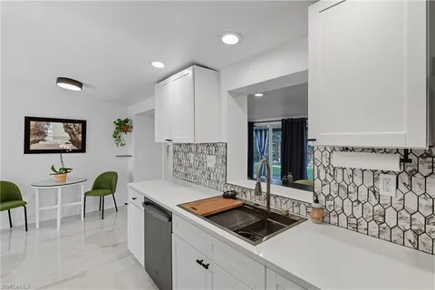 a kitchen with stainless steel appliances kitchen island granite countertop a sink and cabinets