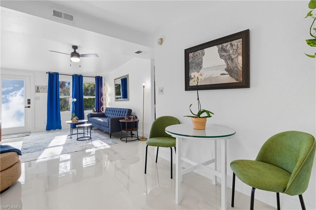 1280 Pine Street Naples, FL 34104 - Photo 16 of 36 a living room with furniture and a chandelier