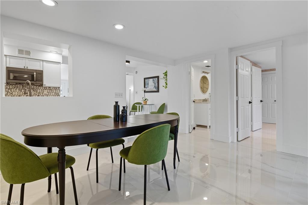 1280 Pine Street Naples, FL 34104 - Photo 17 of 36 a view of a dining room with furniture and wooden floor