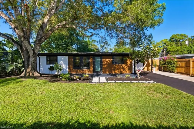 a view of a house with backyard porch and sitting area