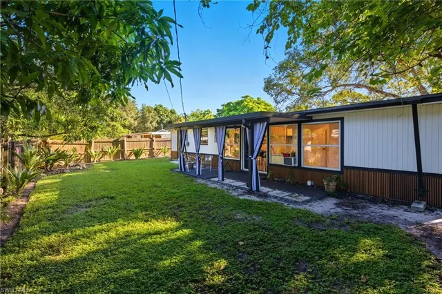 a view of house with backyard porch and garden