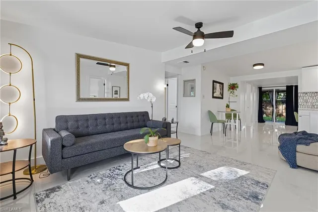 a living room with furniture a rug and a chandelier