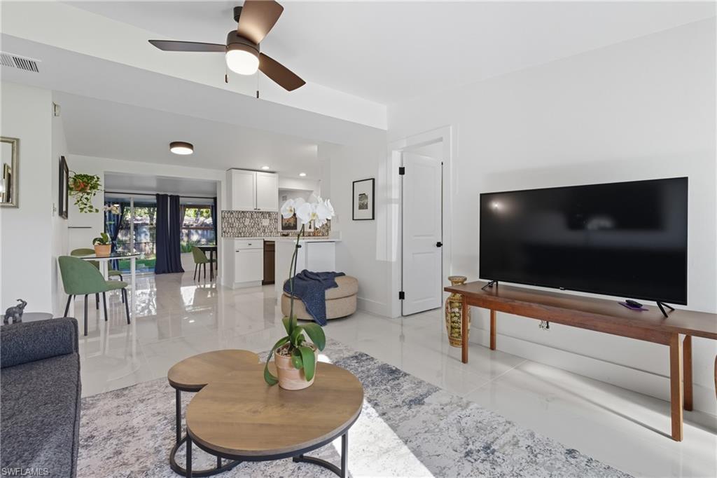 1280 Pine Street Naples, FL 34104 - Photo 3 of 36 a living room with furniture and a flat screen tv