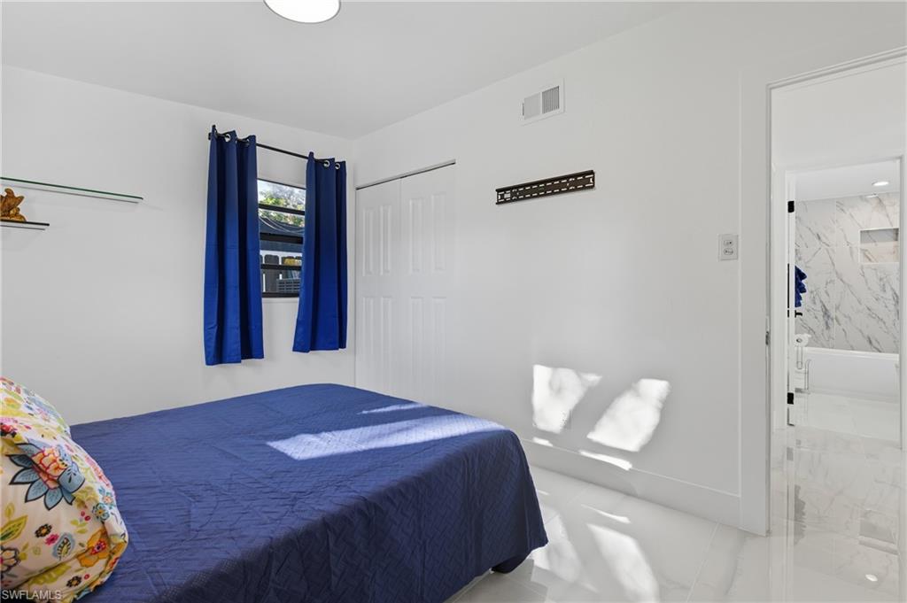 1280 Pine Street Naples, FL 34104 - Photo 31 of 36 a bedroom with a bed and a window