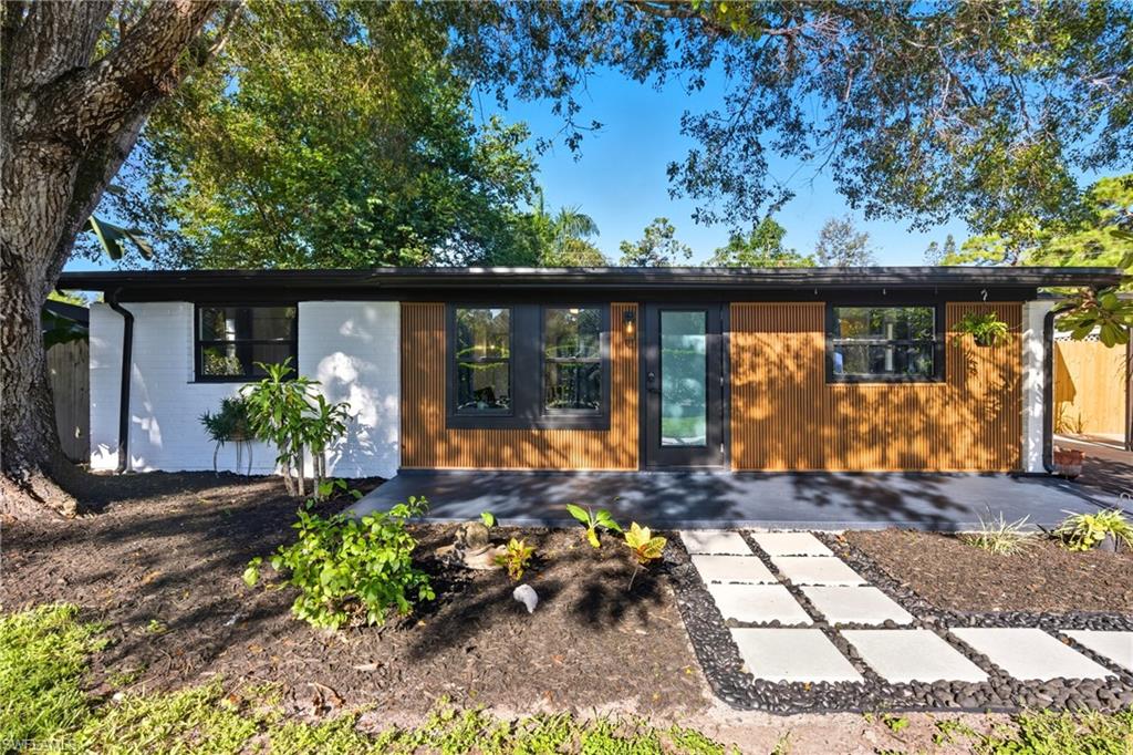 1280 Pine Street Naples, FL 34104 - Photo 32 of 36 a front view of a house with a yard
