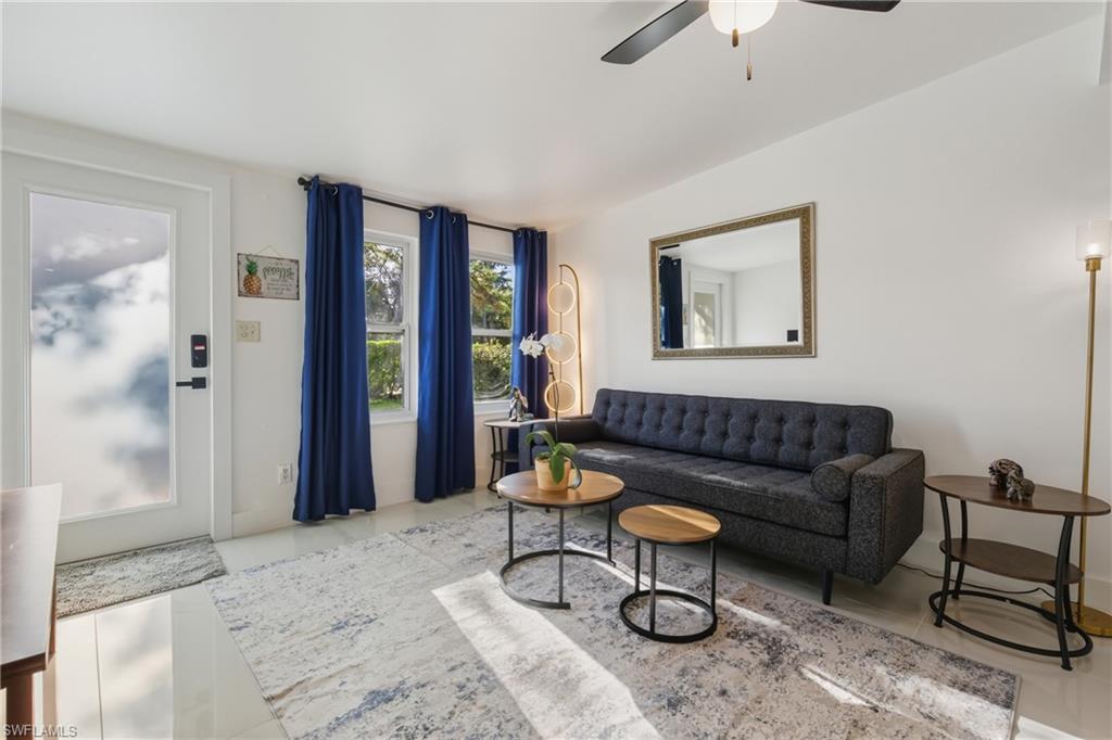 1280 Pine Street Naples, FL 34104 - Photo 4 of 36 a living room with furniture and a painting on the wall