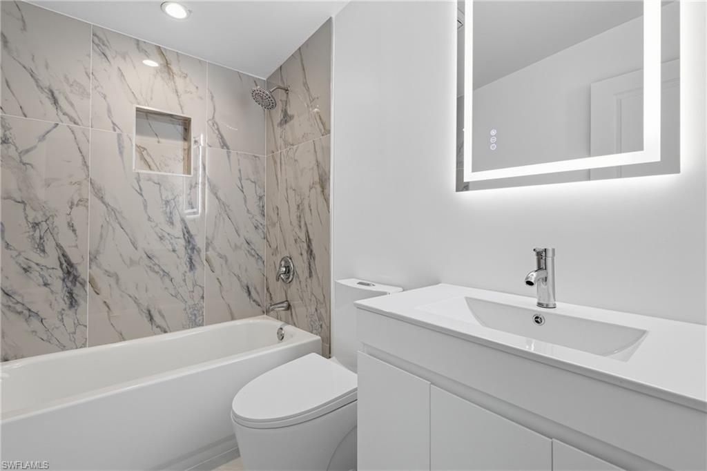 1280 Pine Street Naples, FL 34104 - Photo 5 of 36 a bathroom with a sink a toilet and shower