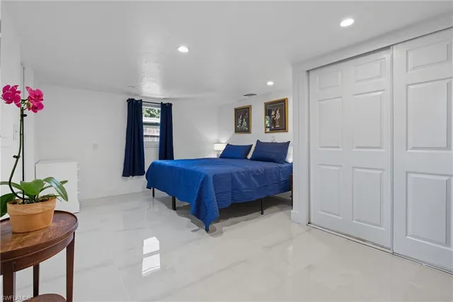a bedroom with a bed and a potted plant