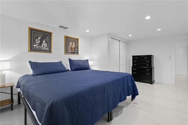 a bedroom with a bed and a walk in closet