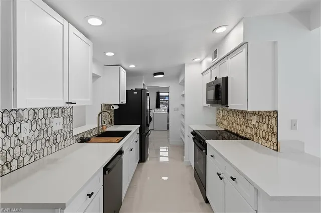 a kitchen that has a lot of cabinets and wooden floor