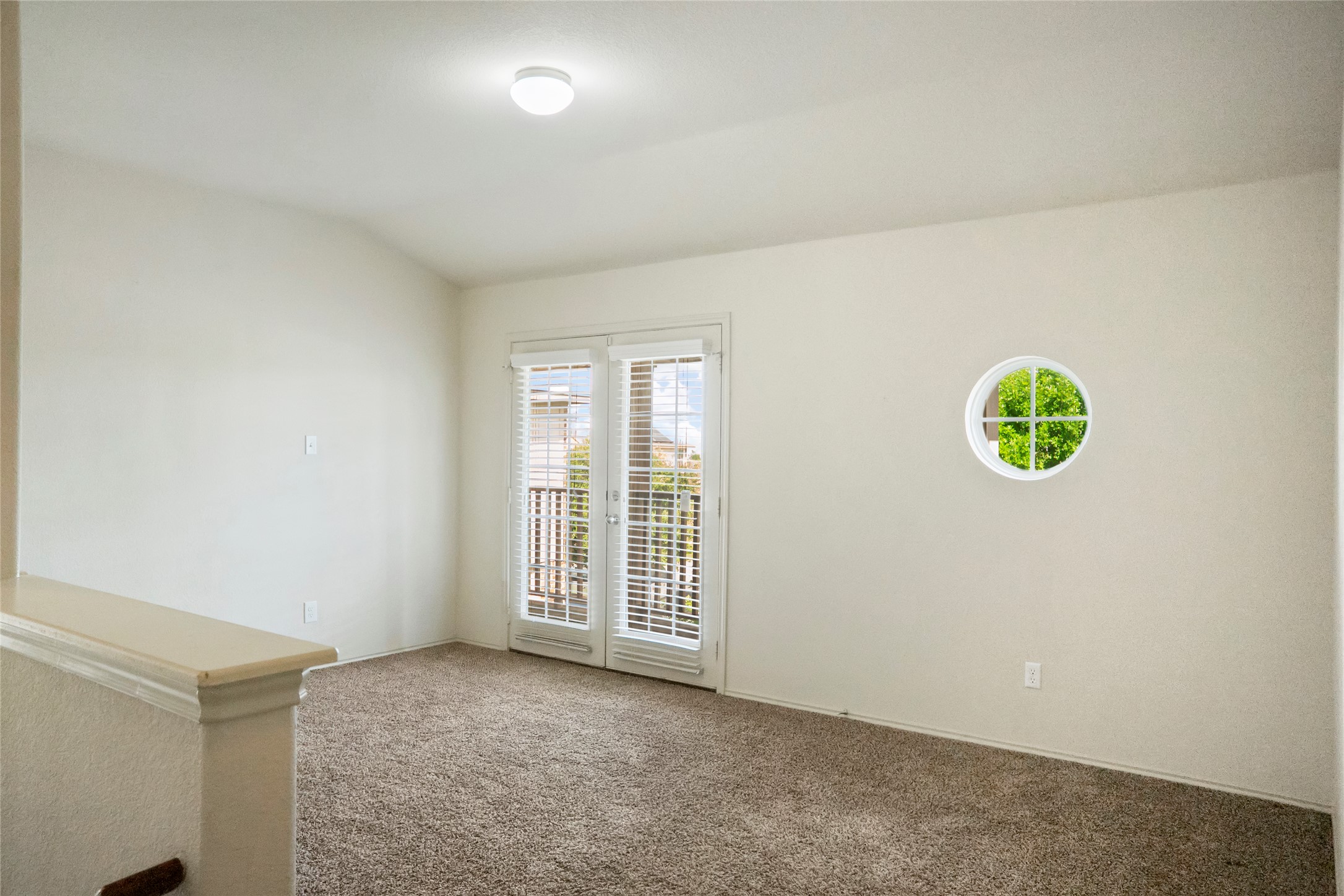 212 Foster Lane Jarrell, TX 76537 - Photo 11 of 22 Spacious loft/living room fully carpeted, featuring a double French door balcony access