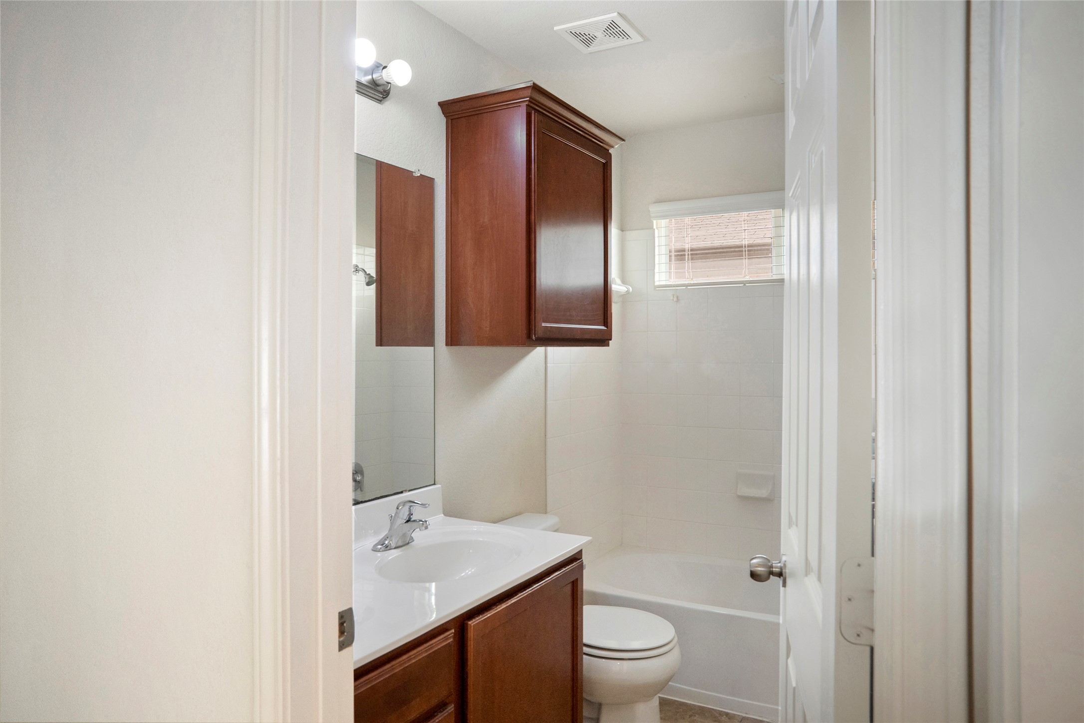 212 Foster Lane Jarrell, TX 76537 - Photo 14 of 22 Bathroom featuring a single vanity with lots of counter space, wood-finish cabinetry, and white countertop