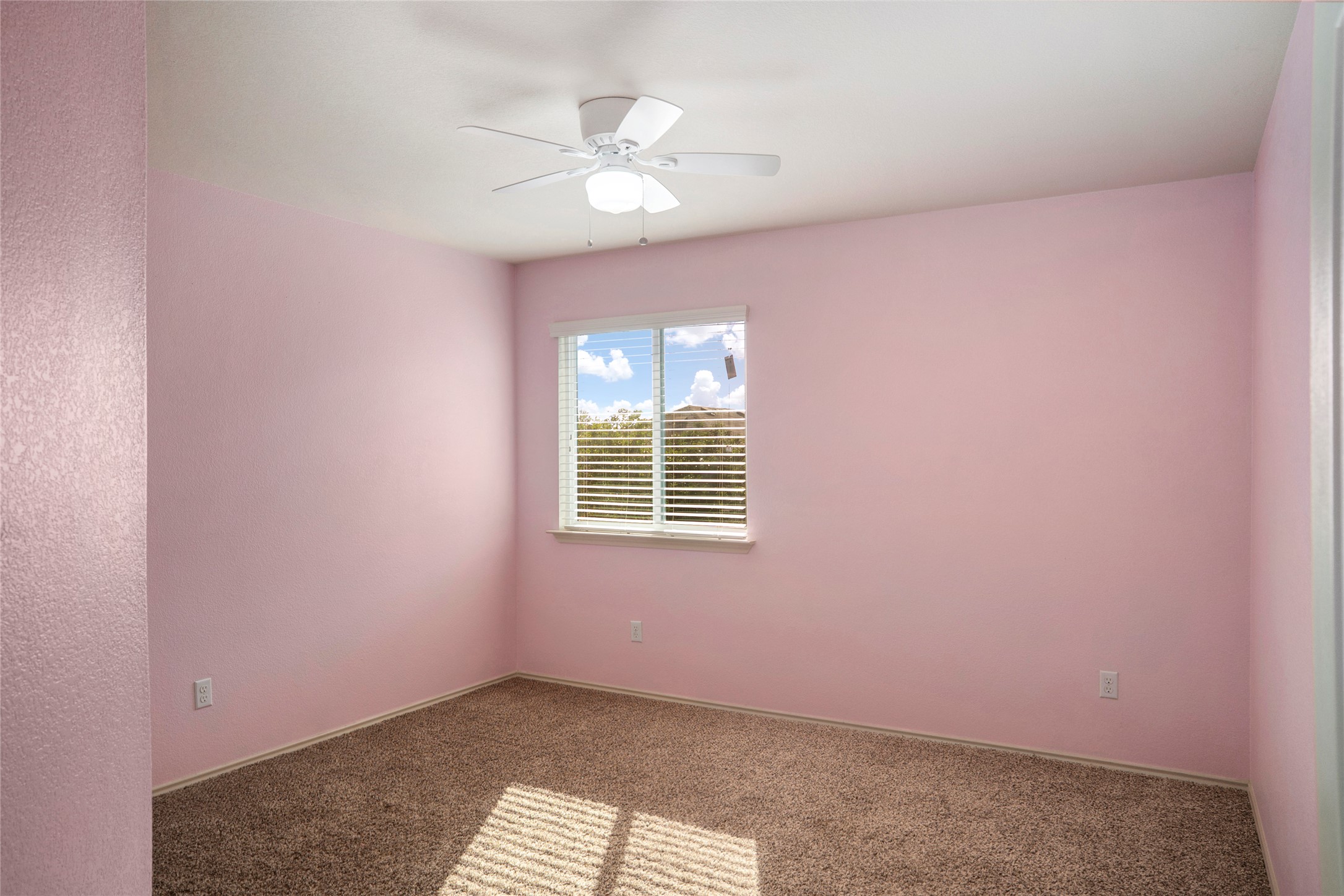 212 Foster Lane Jarrell, TX 76537 - Photo 17 of 22 Bedroom featuring textured wall finishes, a window with horizontal blinds over looking the back yard, ceiling fan with lighting, and carpet flooring