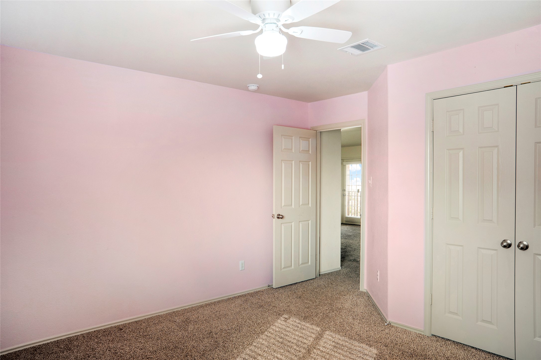 212 Foster Lane Jarrell, TX 76537 - Photo 18 of 22 Carpeted bedroom with white ceiling fan/light and double-door closet space