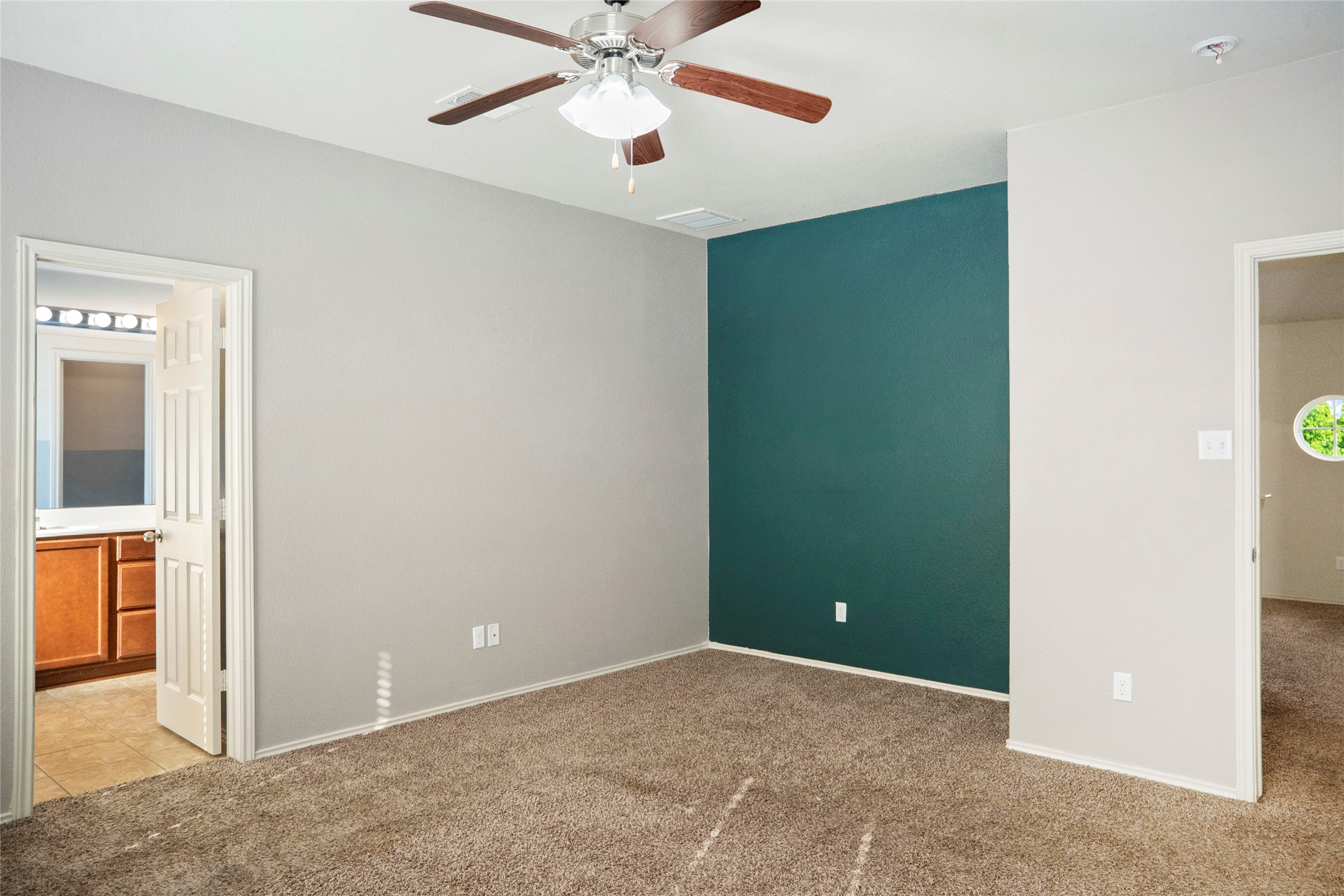 212 Foster Lane Jarrell, TX 76537 - Photo 19 of 22 Bedroom featuring a accent wall and ceiling fan with light