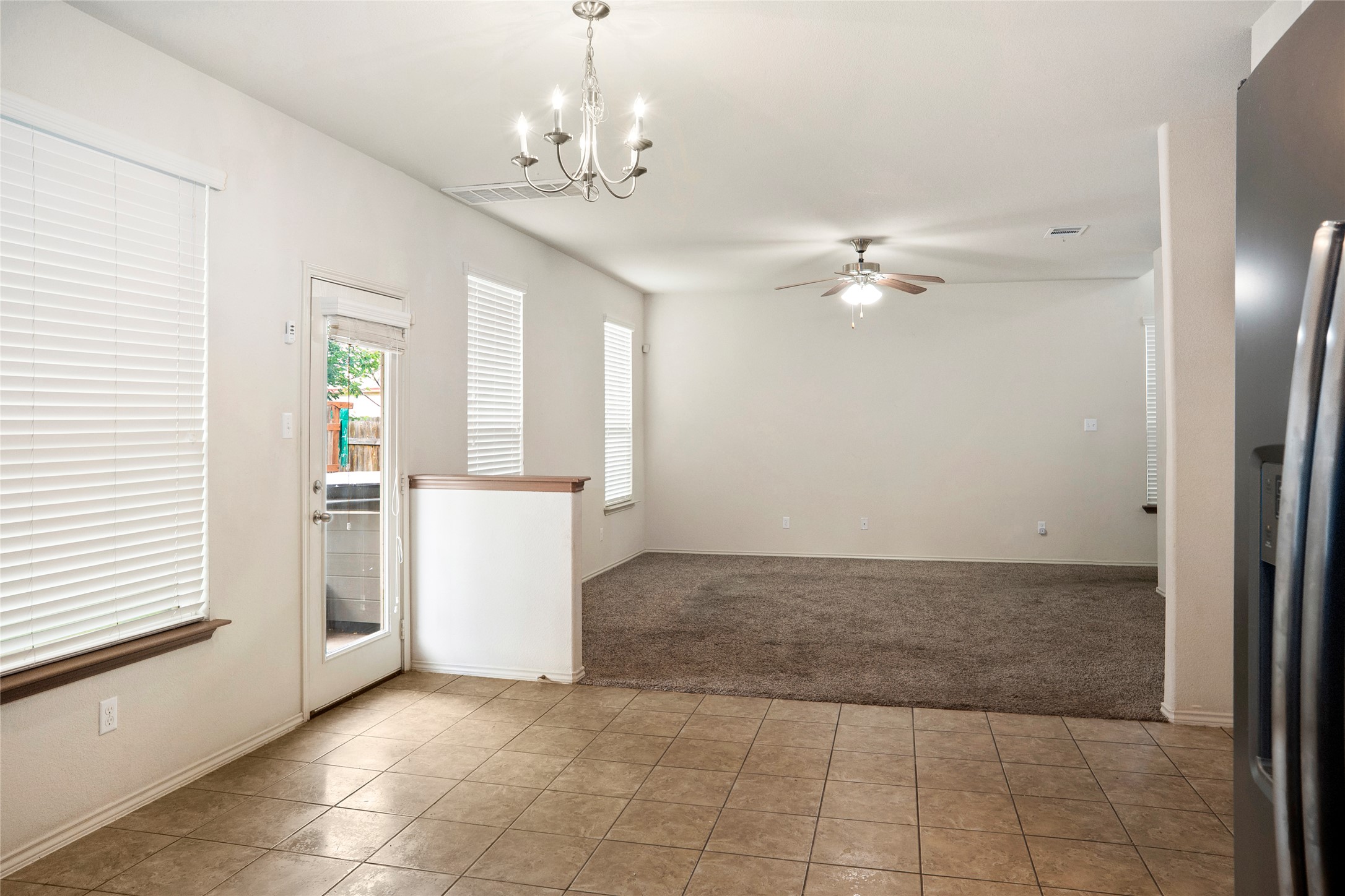 212 Foster Lane Jarrell, TX 76537 - Photo 5 of 22 Eat-in kitchen with chandelier lighting leading into living room