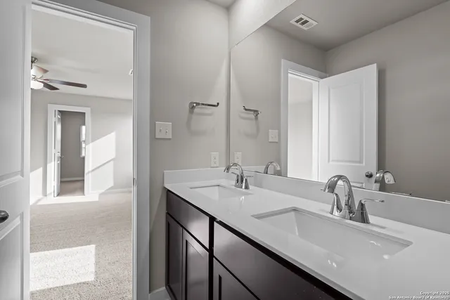 a bathroom with a sink double vanity and a mirror