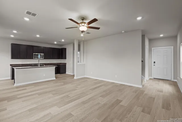 a view of a kitchen with a sink and a stove top oven
