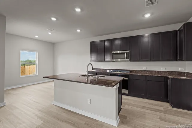 a kitchen with a sink and a microwave