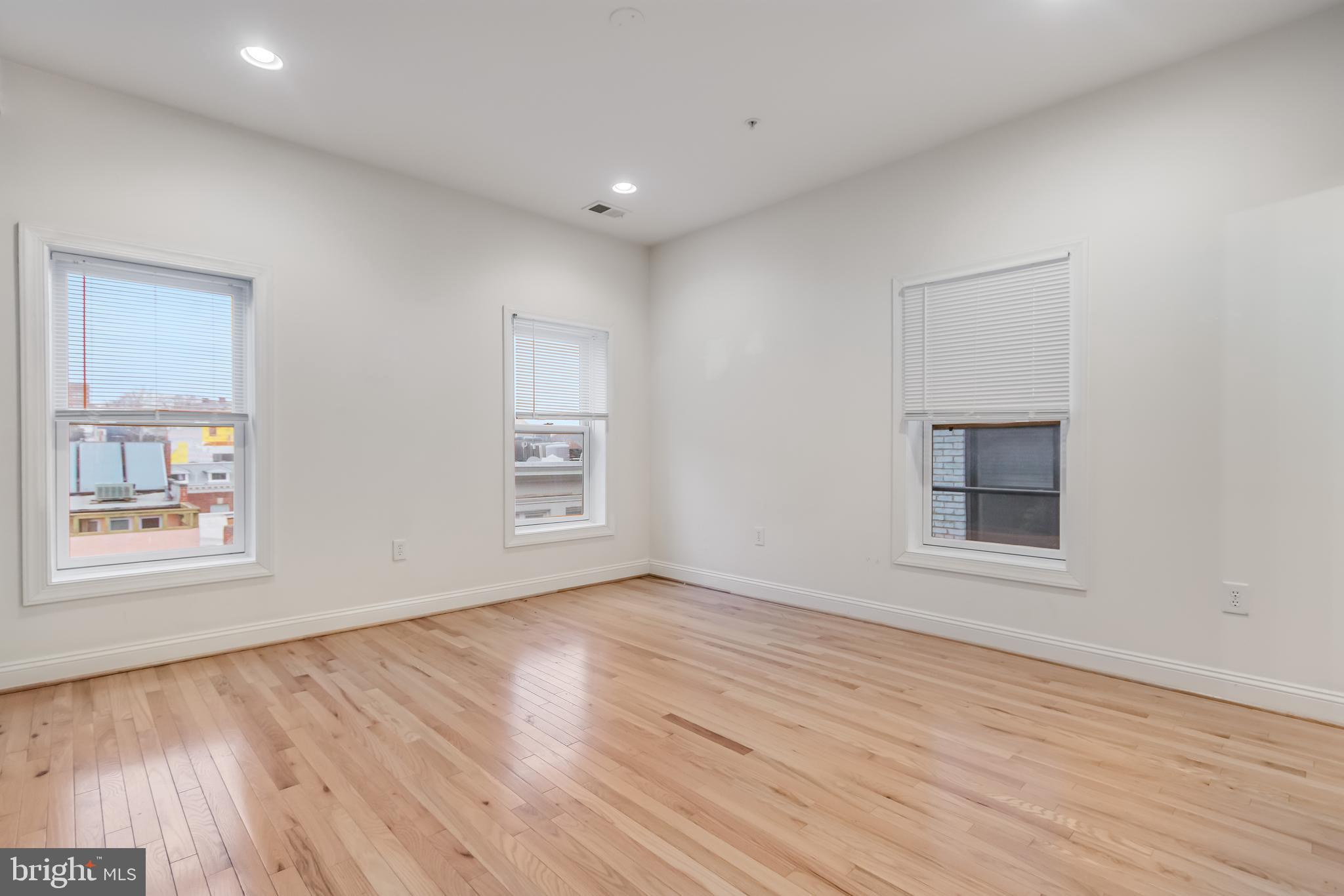2307 18th Street Northwest, Unit 1 Washington, DC 20009 - Photo 12 of 21 an empty room with wooden floor and windows
