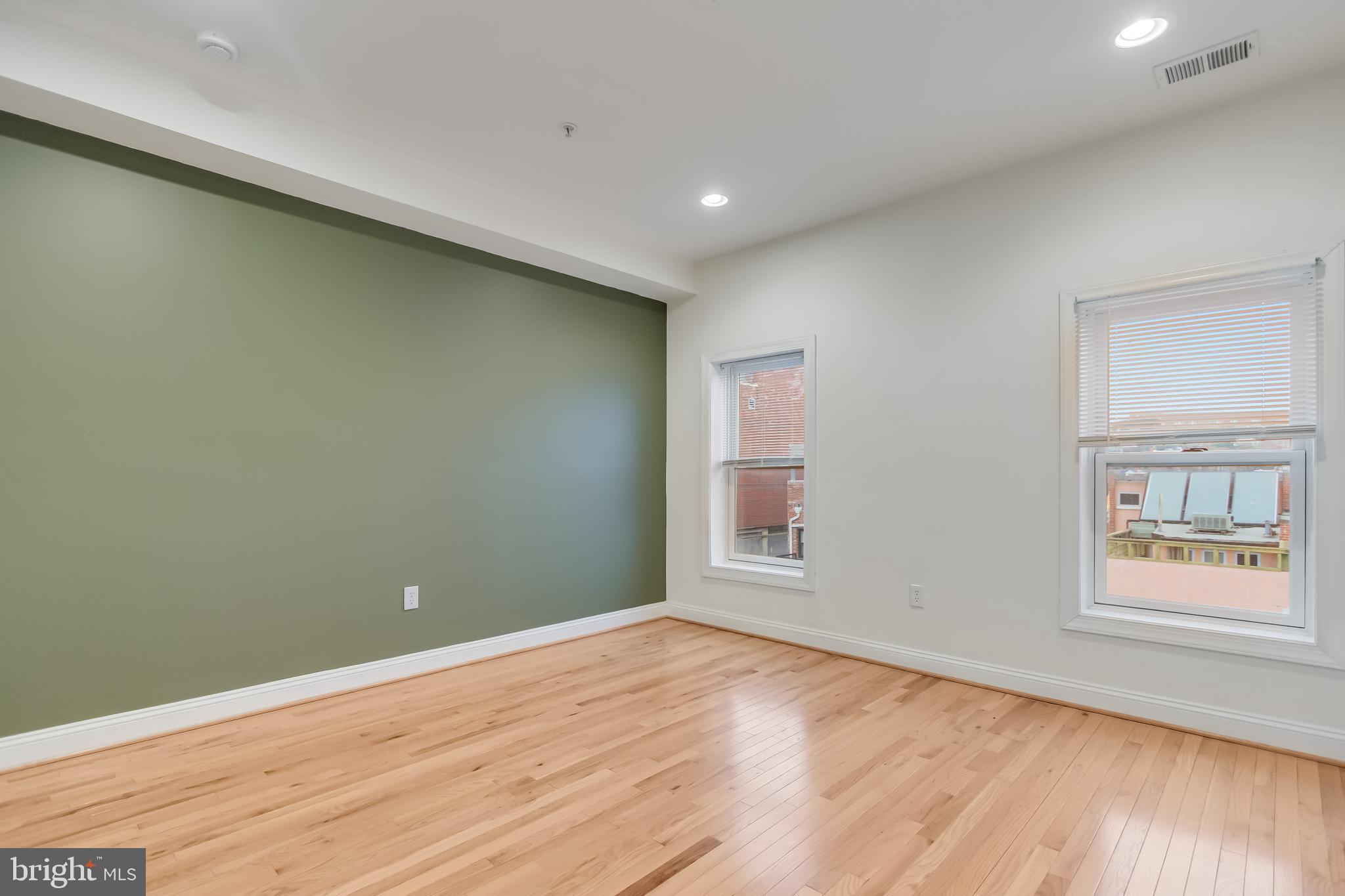 2307 18th Street Northwest, Unit 1 Washington, DC 20009 - Photo 13 of 21 an empty room with wooden floor and windows
