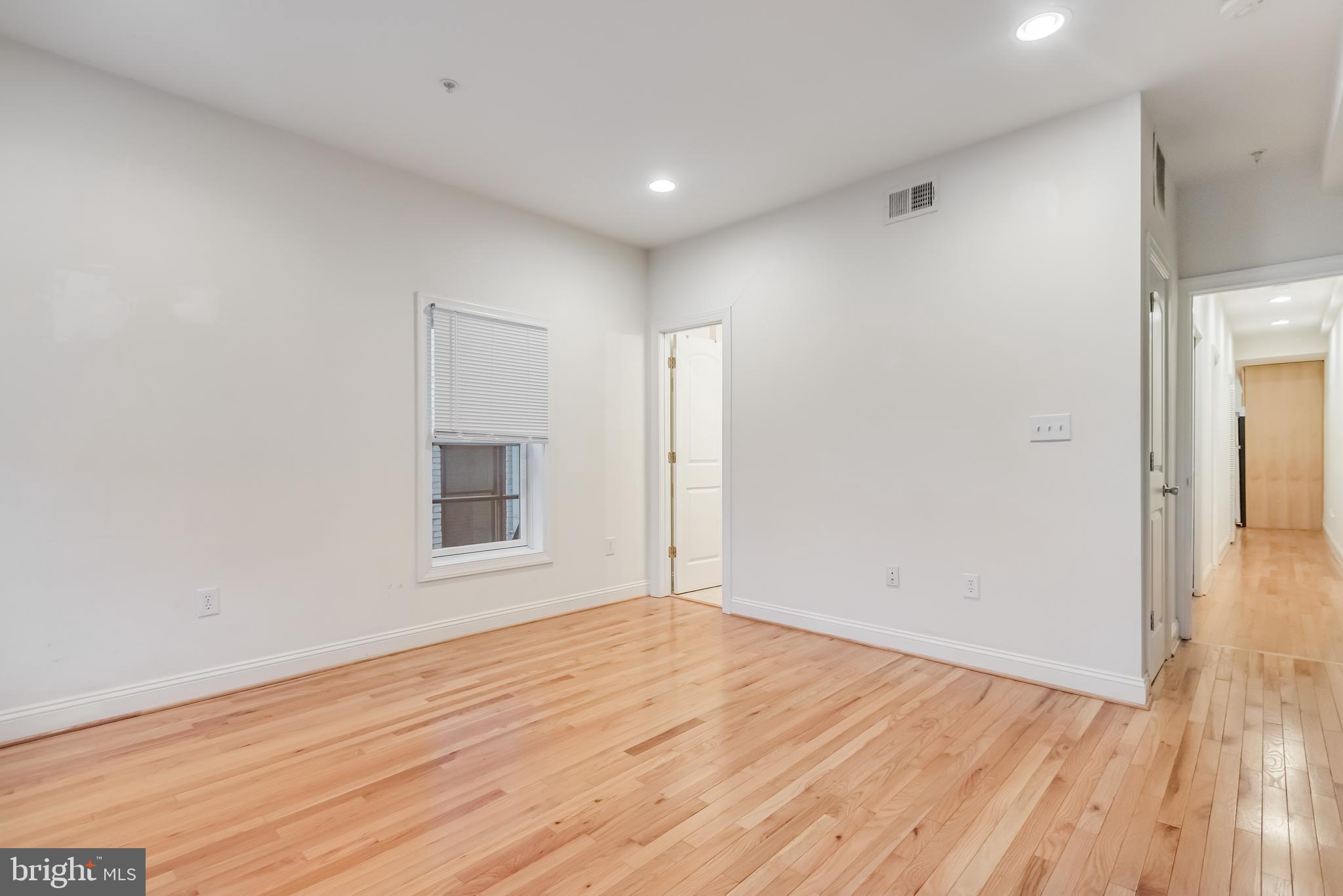 2307 18th Street Northwest, Unit 1 Washington, DC 20009 - Photo 14 of 21 an empty room with wooden floor and windows