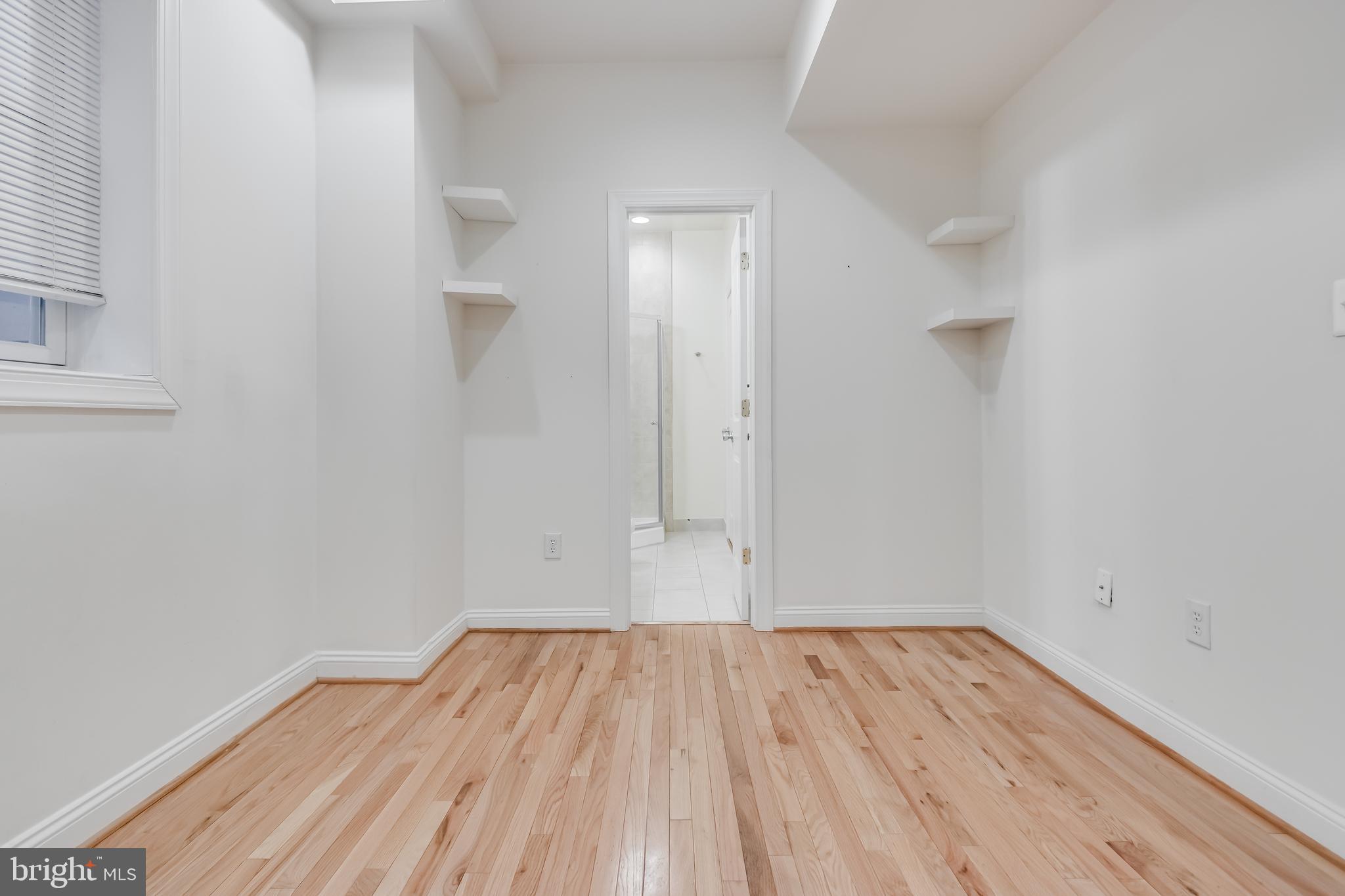2307 18th Street Northwest, Unit 1 Washington, DC 20009 - Photo 19 of 21 a view of a room with wooden floor and white walls