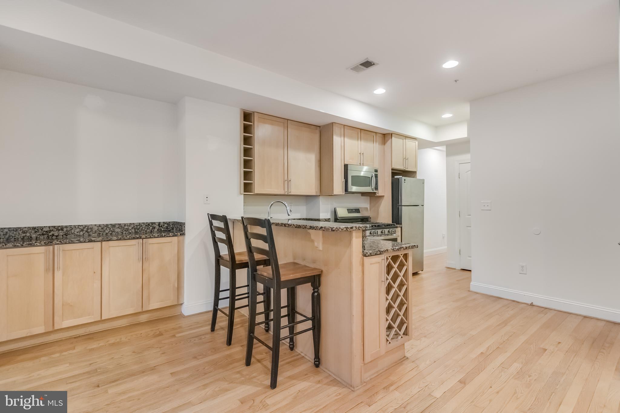 2307 18th Street Northwest, Unit 1 Washington, DC 20009 - Photo 6 of 21 a view of kitchen with stainless steel appliances refrigerator microwave and stove
