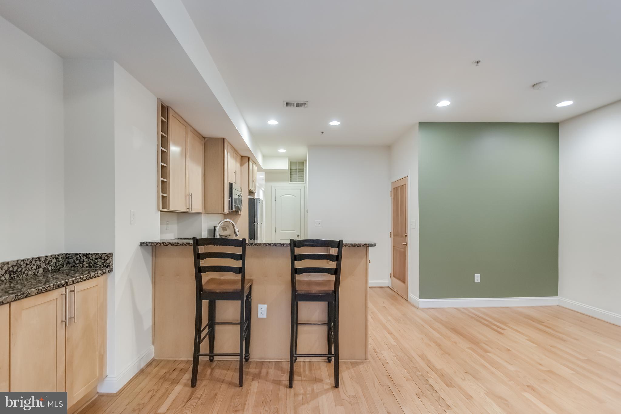 2307 18th Street Northwest, Unit 1 Washington, DC 20009 - Photo 7 of 21 a view of kitchen with refrigerator stove and wooden floor