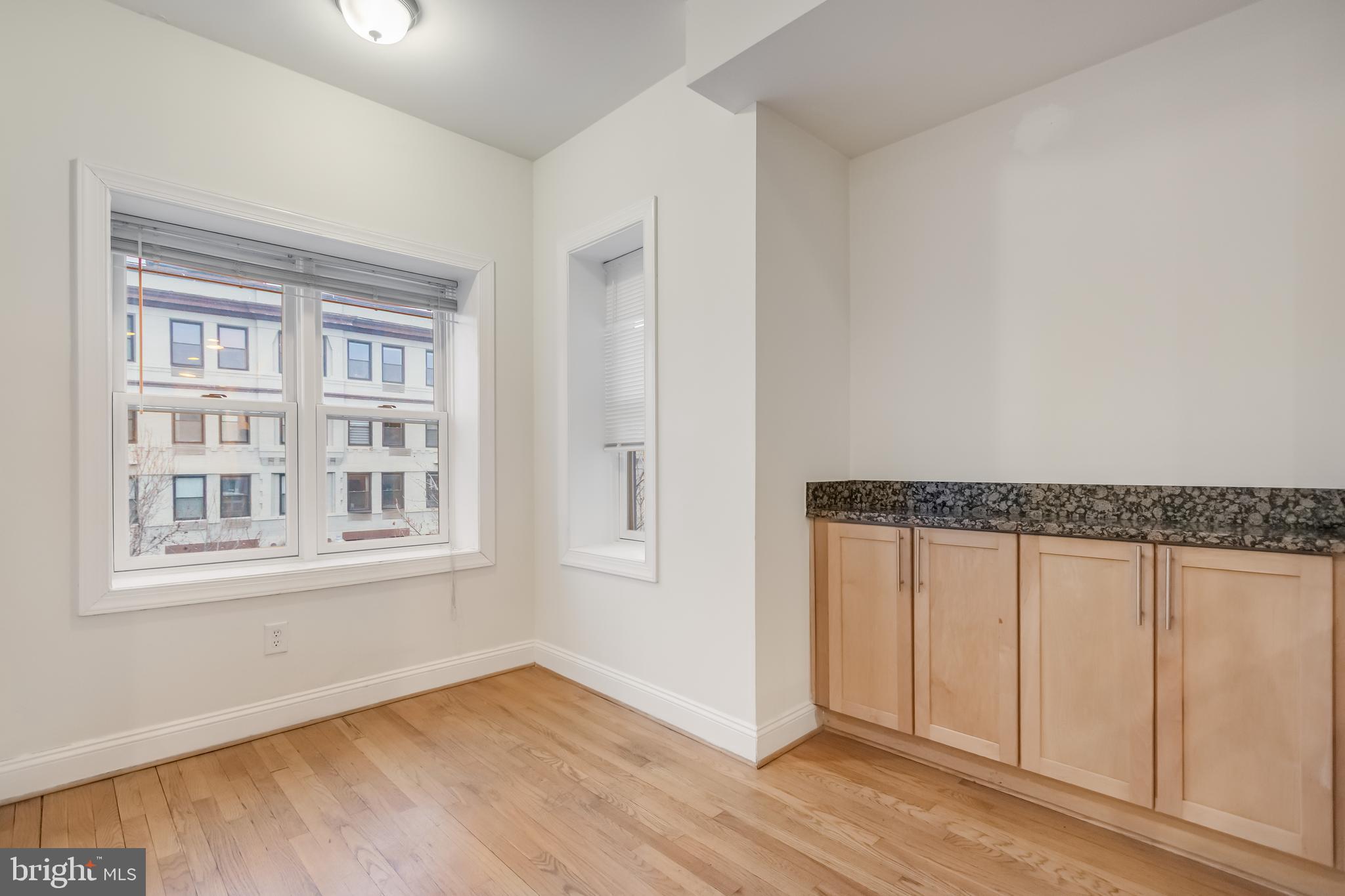 2307 18th Street Northwest, Unit 1 Washington, DC 20009 - Photo 9 of 21 an empty room with wooden floor and windows