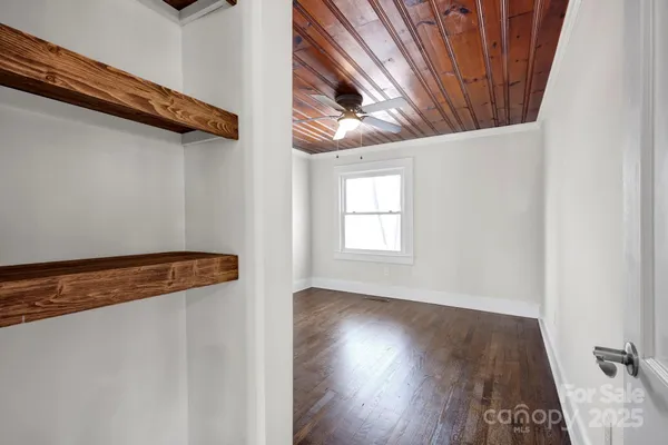 a view of a room with wooden floor and stairs