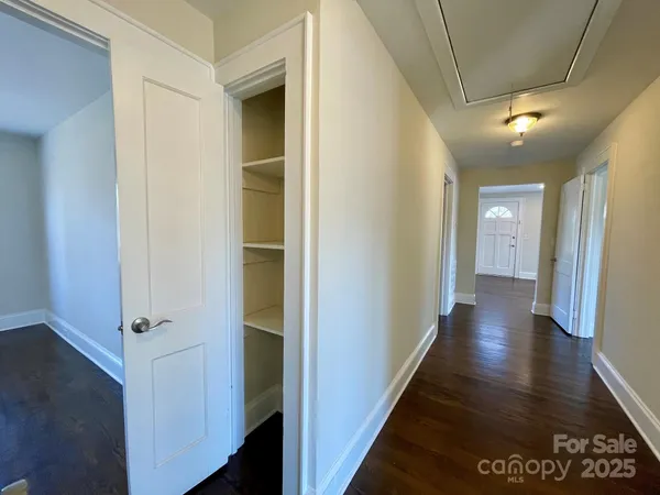 a view of hallway with wooden floor