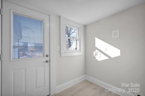 a view of an empty room with windows and closet