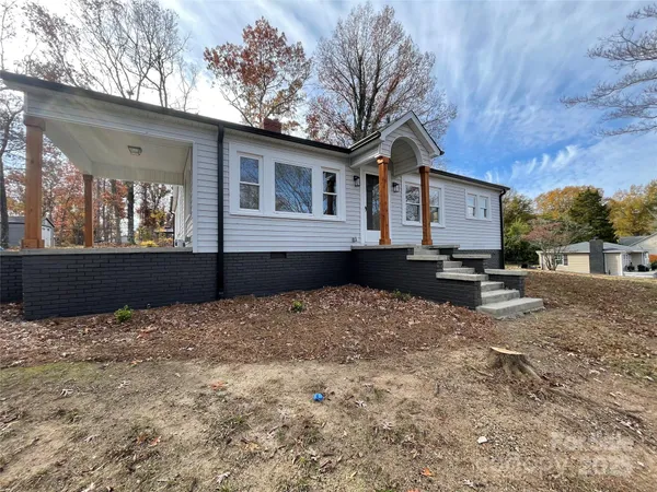 a house that has a tree in front of it