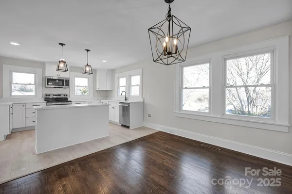 a view of a kitchen with an empty space and a window