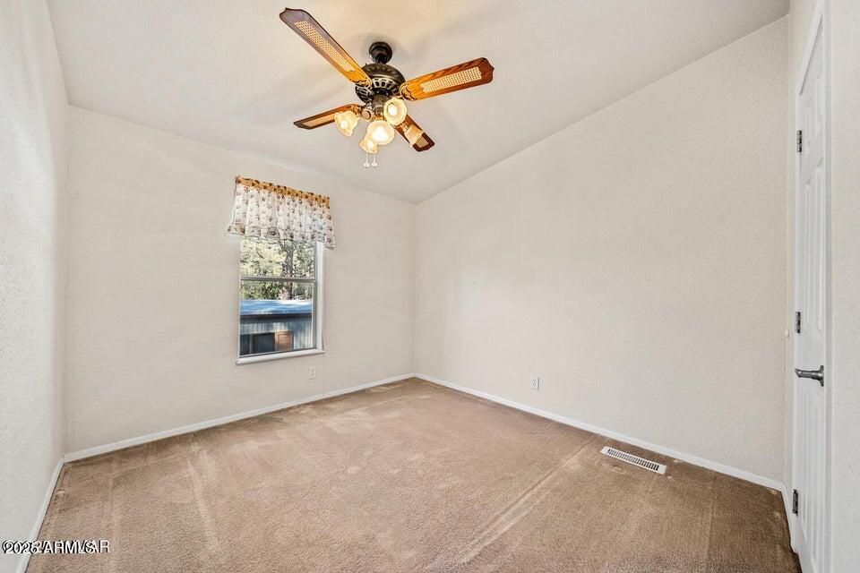 2421 West Thornton Road Show Low, AZ 85901 - Photo 29 of 48 an empty room with a window