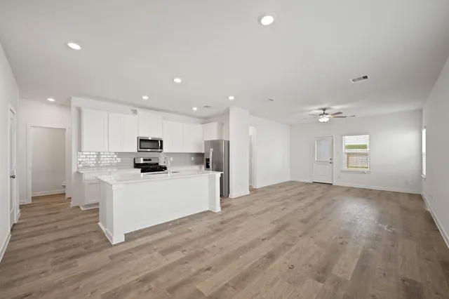 a view of kitchen with sink microwave and refrigerator