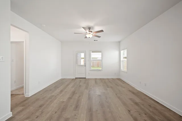 wooden floor in an empty room with a window