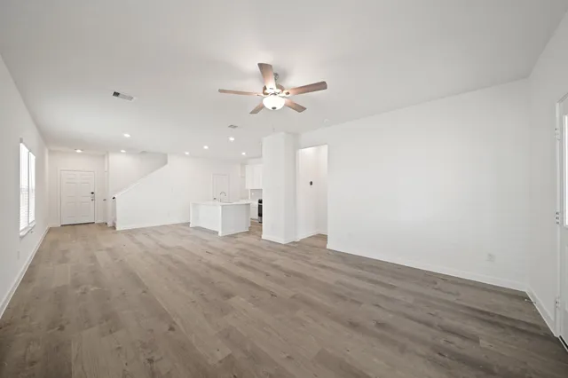 a view of an empty room with a ceiling fan