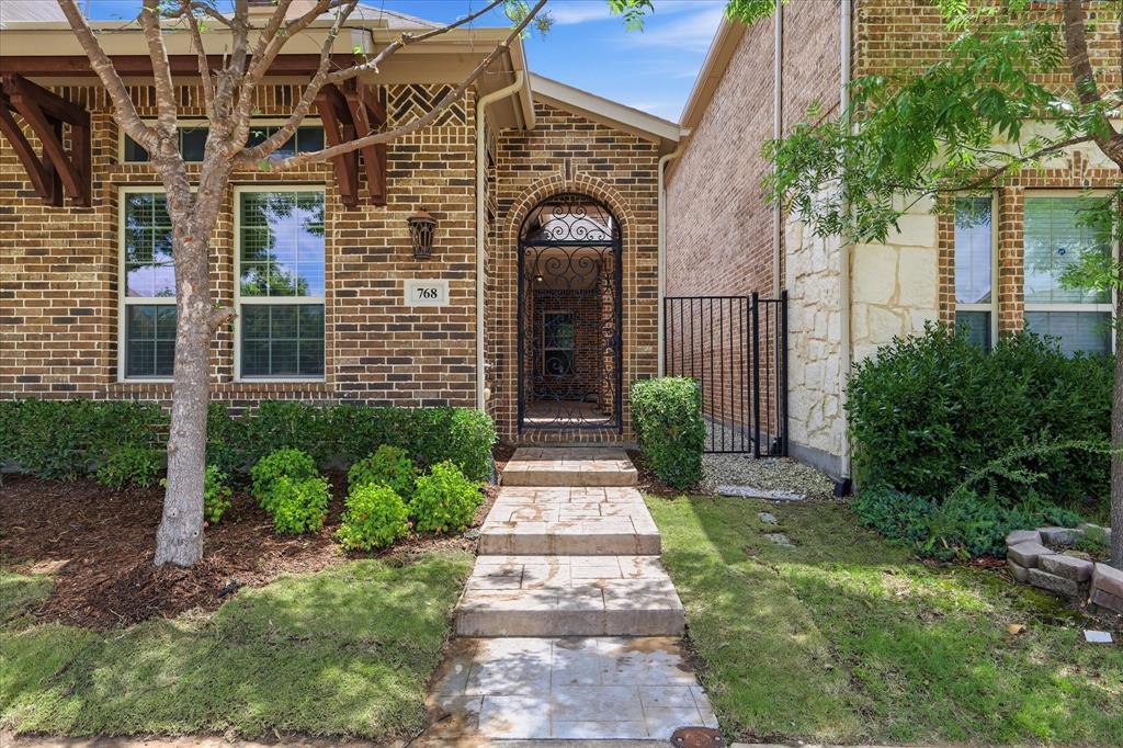 768 Huntingdon Street Coppell, TX 75019 - Photo 2 of 37 A beautiful gated courtyard-style entry offers privacy, charm, and a memorable arrival experience.