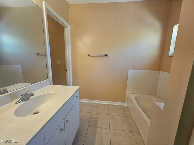 a bathroom with a sink and mirror with toilet