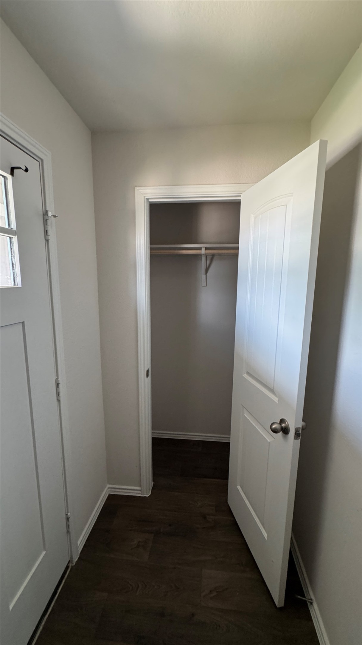 408 Frogmore Loop Kyle, TX 78640 - Photo 27 of 32 Enter into a practical hallway featuring rich hardwood flooring and a convenient storage closet.