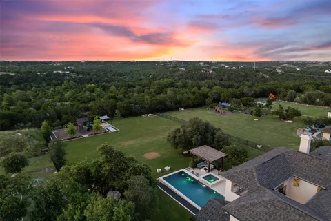 an aerial view of a house with a big yard