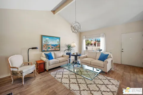 a living room with furniture a dining table and a large window