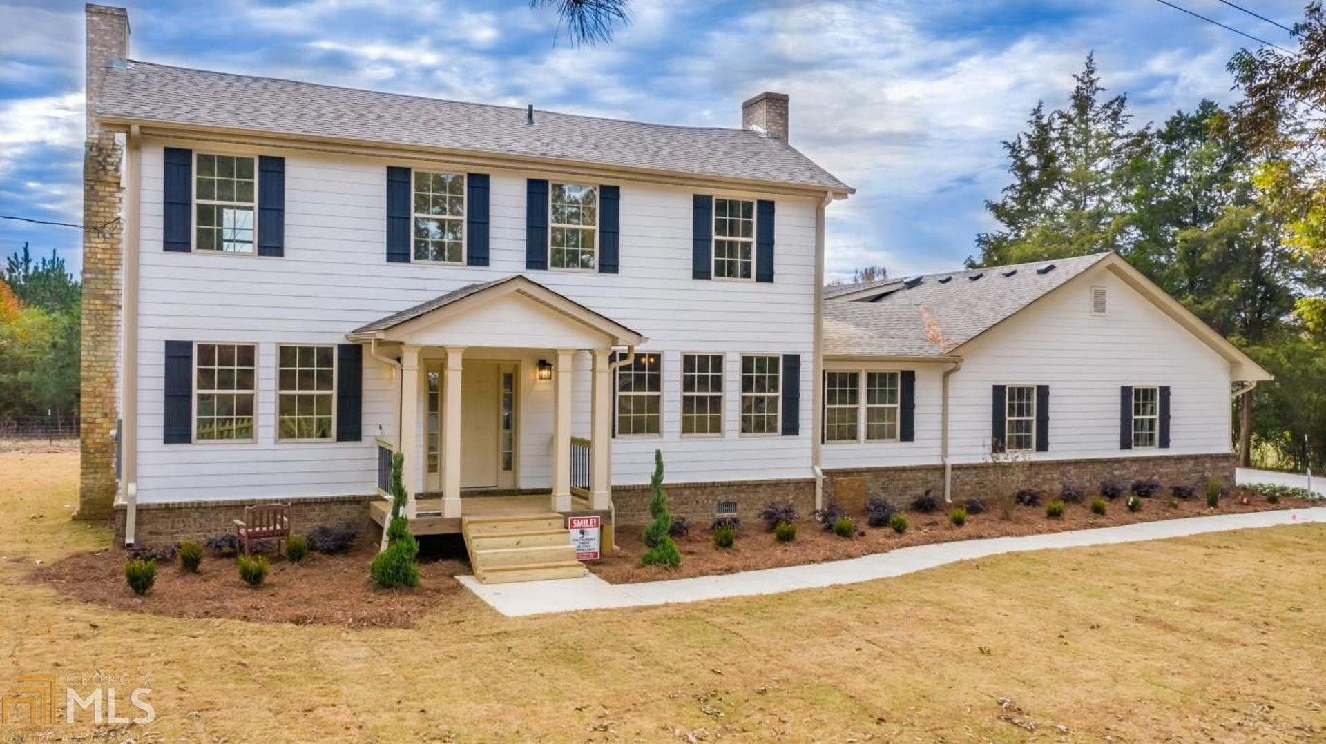 a front view of a house with a yard outdoor seating and pathway