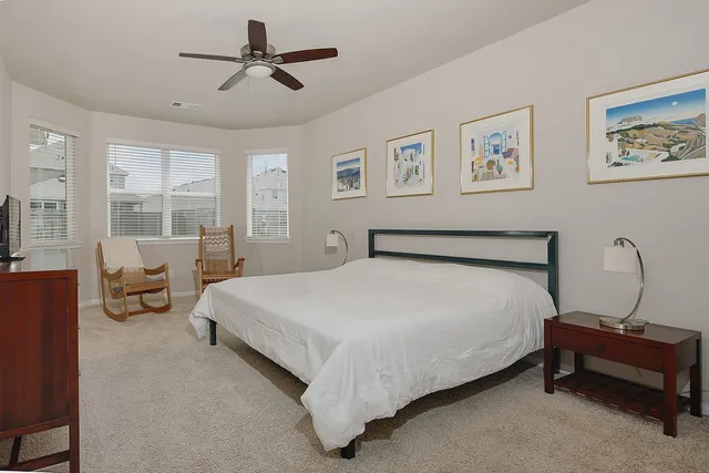 a bedroom with bed and window